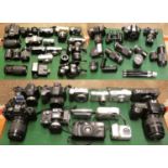 An assortment of cameras, binoculars, and lenses in four boxes.(untested)