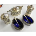 A silver five piece cruet, Sheffield 1937, of pierced form with blue glass liners.