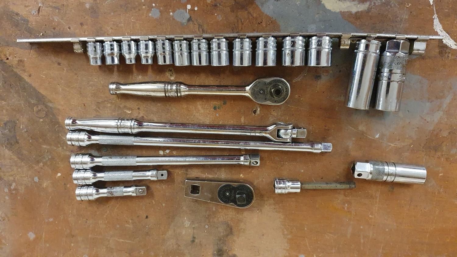 A Snap On 3/8" drive ratchet, various metric sockets and bars.