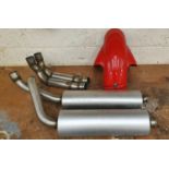 A pair of used Ducati 916 exhausts, down pipe and hugger, together with other motorcycle spares.