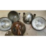 Three unknown headlights and two oil tanks