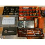 A compression tester, a socket set, a tap and die set a quantity of bulbs and other tools.