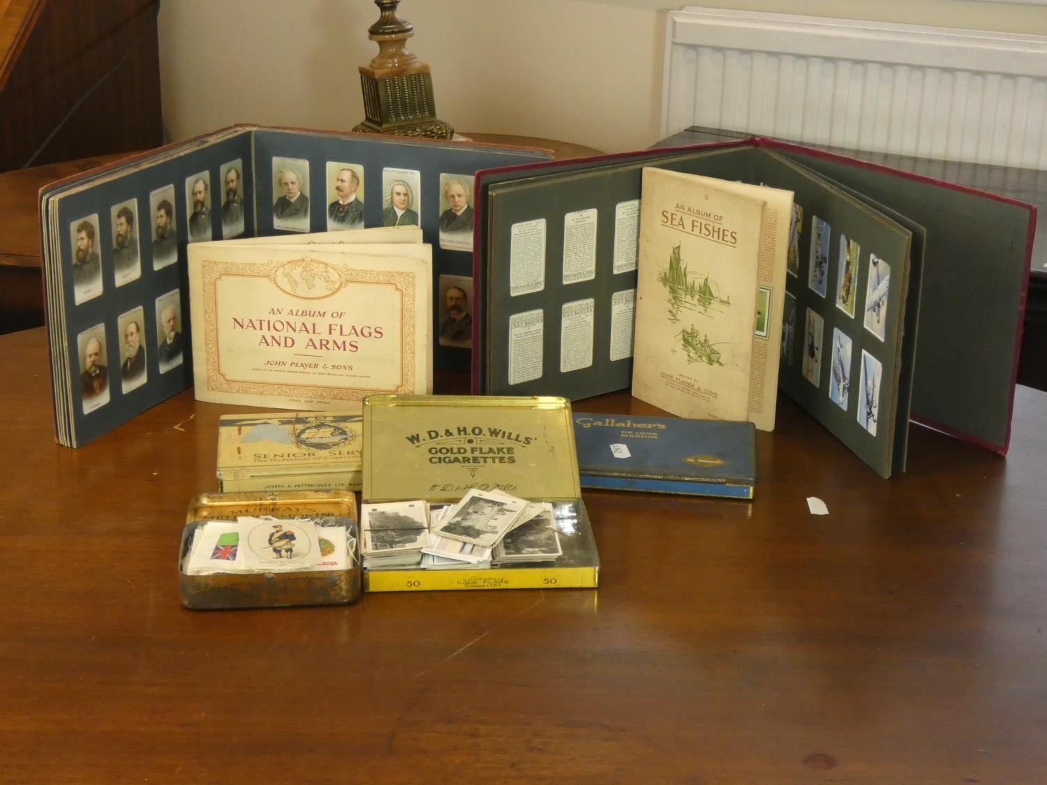 Two albums of cigarette cards together with loose cigarette cards and military silks