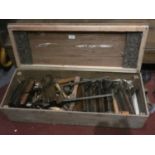 A collection of vintage wood workers tools in a scratch built wooden chest including-block planes,