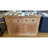 An oak sideboard, with two frieze drawers over two cupboard doors, 133 x 59 x 92 cm.