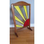 An Art Deco oak firescreen with later stained glass sunburst motif by Reflections Studio of