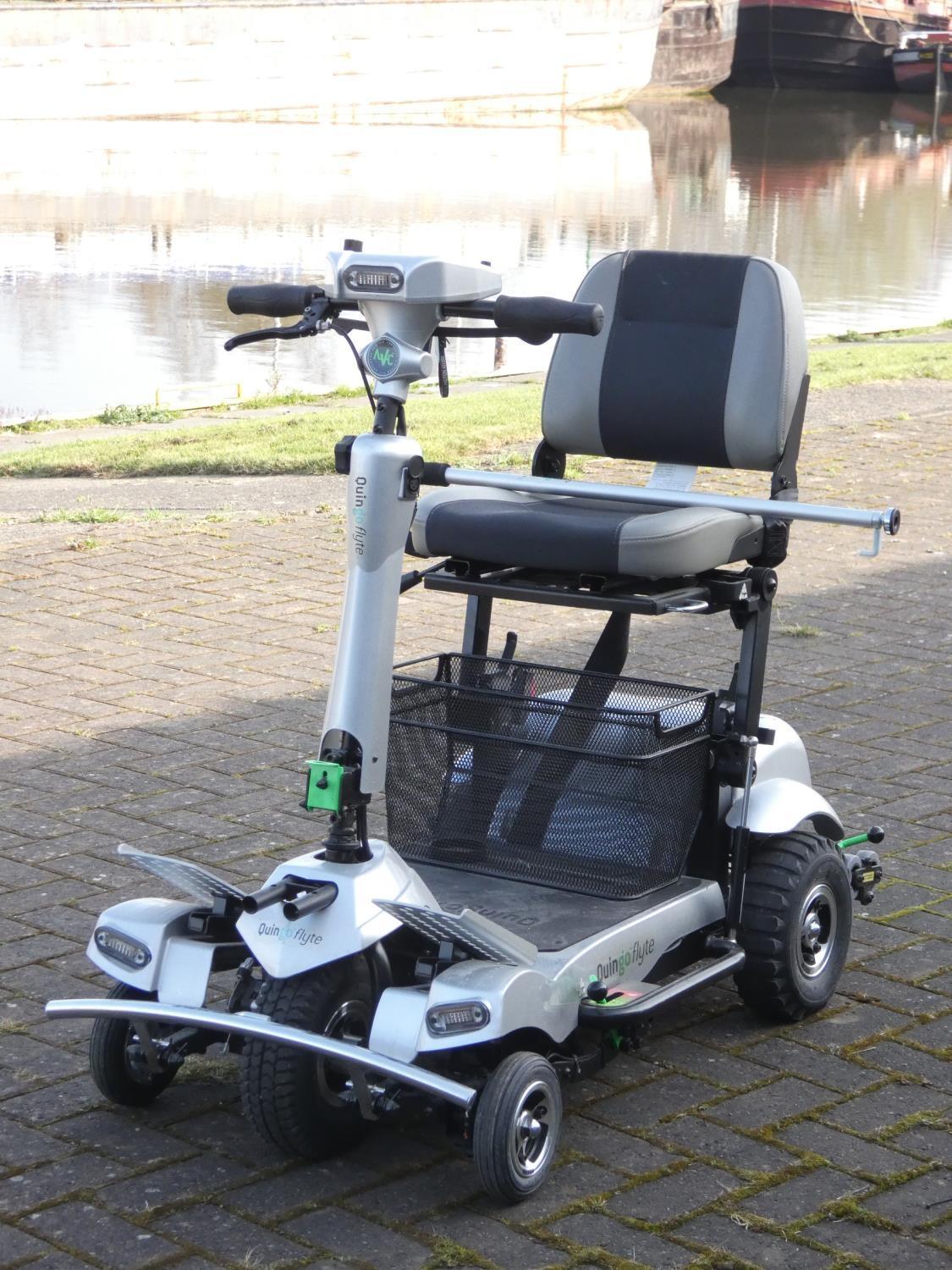 A Quingo Flyte mobility scooter, complete with battery charger