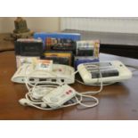 An Amstrad GX4000 games console together with loose and boxed cassette games, two controllers and