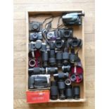 A collection of cameras including a Bell and Howell Microstar z, a Canon EOS 1000Fn and a Kodak