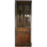 A Victorian mahogany bookcase cabinet, the glazed upper section with painted Dunn & Co motif, over a