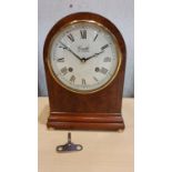 Comitti of London, a burr walnut and brass inlaid striking mantle clock with mechanical movement.