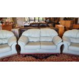 A pale green leather 3 piece suite, comprising 2 seater sofa and 2 armchairs.