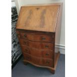 A mahogany serpentine fronted bureau, with fitted intior, a bevel edge mirror and 2 occasional