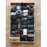 A collection of cameras including a Nikon f-601, a Tokina SL22 and various other film and digital