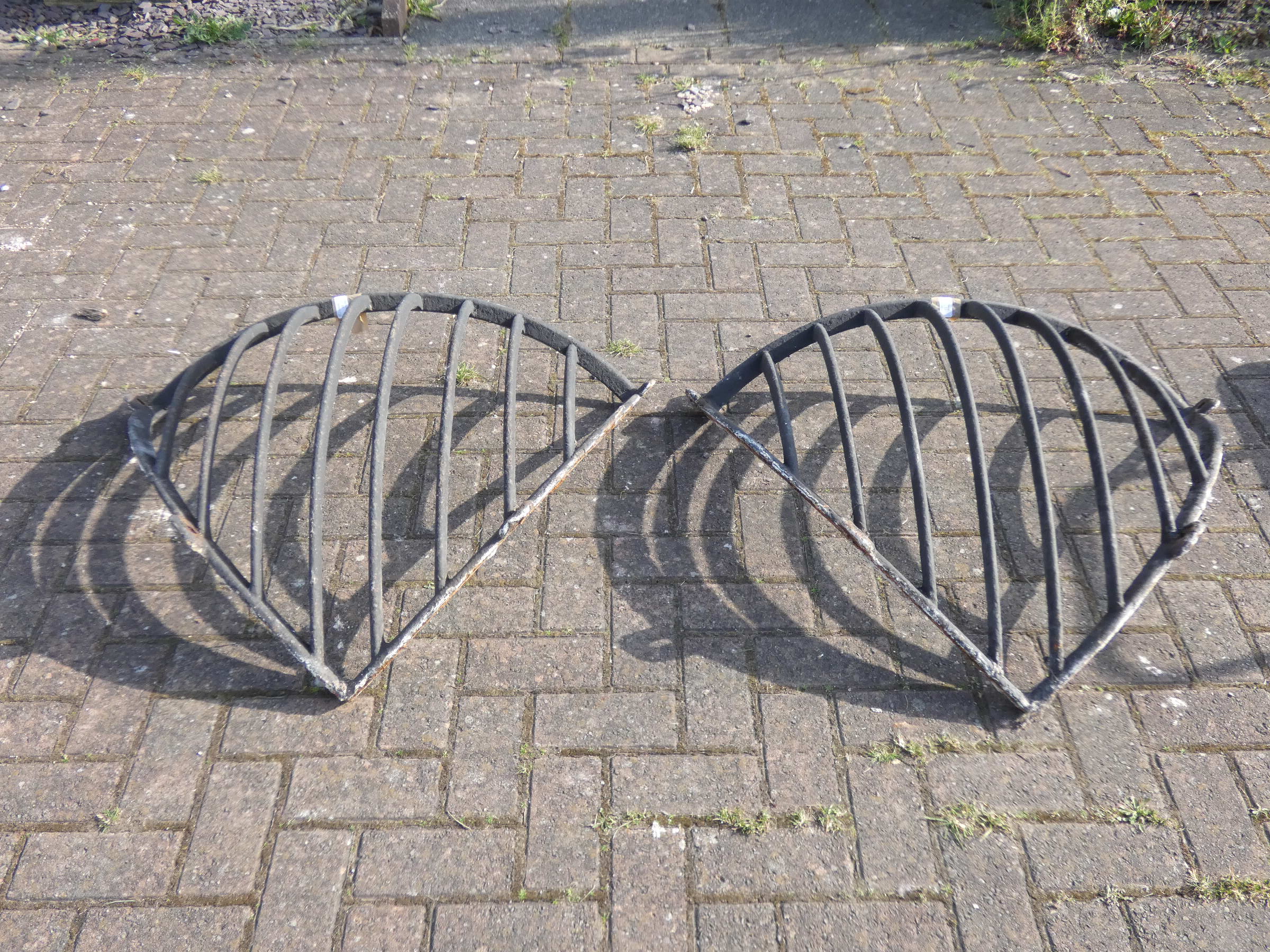 A pair of corner cast iron wall mounted hay racks 81cmx88cm