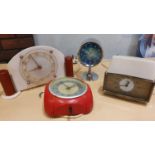 A 1970s Rhythm alarm chrome mantle clock, a 1950's plastic mantle clock and 2 other clocks