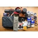 A collection of cameras including a an Olympus OM40, a Canon EOS 650 along with various other