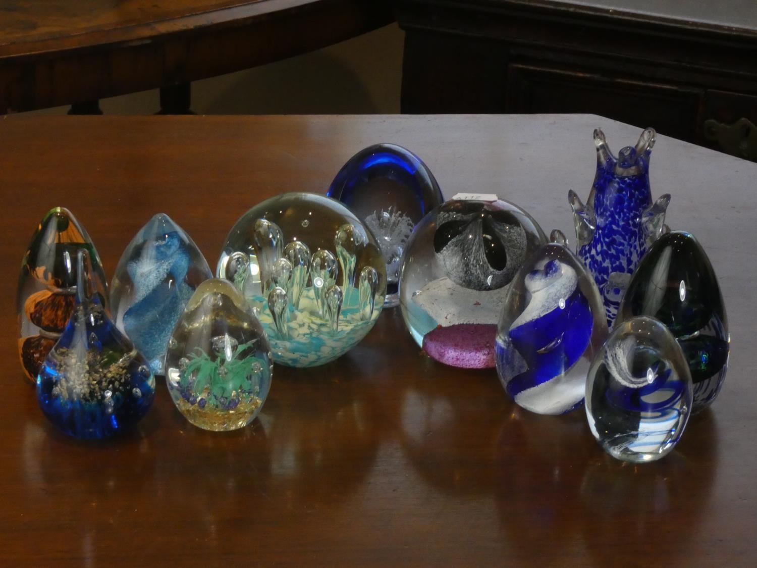 A collection of eleven modern glass paperweights