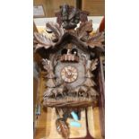 A Bavarian cuckoo clock with owl pediment and other clocks