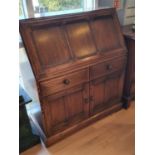 An Ercol Golden Dawn bureau, the drop down flap revealing a fitted interior, over 2 frieze drawers