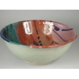 Icehouse Pottery, a large circular stoneware bowl with red, blue and turquoise glaze, diameter 32 cm