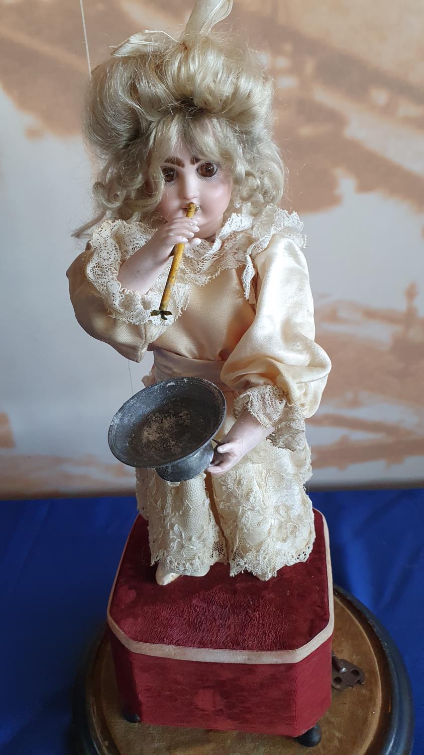 A French lady blowing bubbles automaton with a closed mouth Jumeau head, with brown glass eyes,