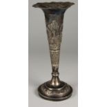 An Indian silver tapering vase, unmarked, embossed with a village scene, height 22 cm, weight 5.5