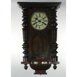 Gustave Becker, a Vienna style walnut wall clock, with turned supports, pendulum, key, 90 cm.