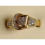 An 18ct gold and diamond buckle ring, pave set with brilliant cut stones, size S, 5.5 gms.