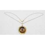 A 9ct gold mounted smokey quartz pendant, claw set with a mixed cut stone, 3 x 2.5 cm, chain, weight