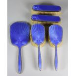 A silver and enamel five piece dressing table set, Birmingham 1932, with blue guilloche enamel