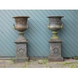 A Victorian good quality pair of cast iron garden urns, twin handle with gadrooned borders and