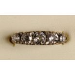 A Victorian 18ct gold five stone diamond ring, carved claw set with graduated stones with points