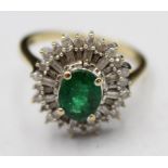 A 9ct gold emerald and diamond cluster ring, the claw set oval stone bordered by baguette and