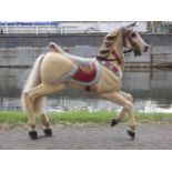 A Victorian fairground carousel galloper horse, the jointed wooden body with carved detail, named
