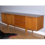 Victor Wilkins For G Plan, a teak sideboard, c.1970s, with drinks cabinet, then three drawers, (