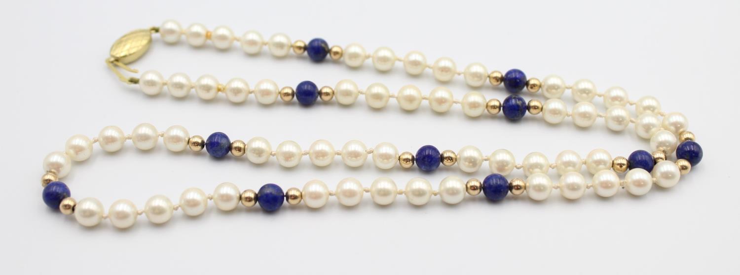 A cultured pearl and lapis lazuli bead necklace, 9ct gold clasp, length 60 cm.