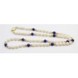 A cultured pearl and lapis lazuli bead necklace, 9ct gold clasp, length 60 cm.