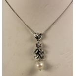 A white gold, cultured pearl and diamond set pendant, length 35mm, to a 18ct white gold chain.