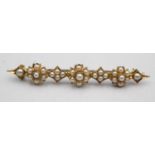 A Victorian gold and pearl bar brooch, set with half pearls, 7 gms, length 6 cm.