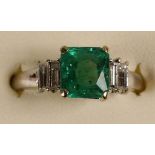 An 18k white gold, emerald and diamond ring, claw set with a step cut stone, stated weight 1.