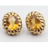 A pair of 9ct gold earstuds, claw set with an oval mixed cut citrine, 15 x 13 mm, 4 gms.