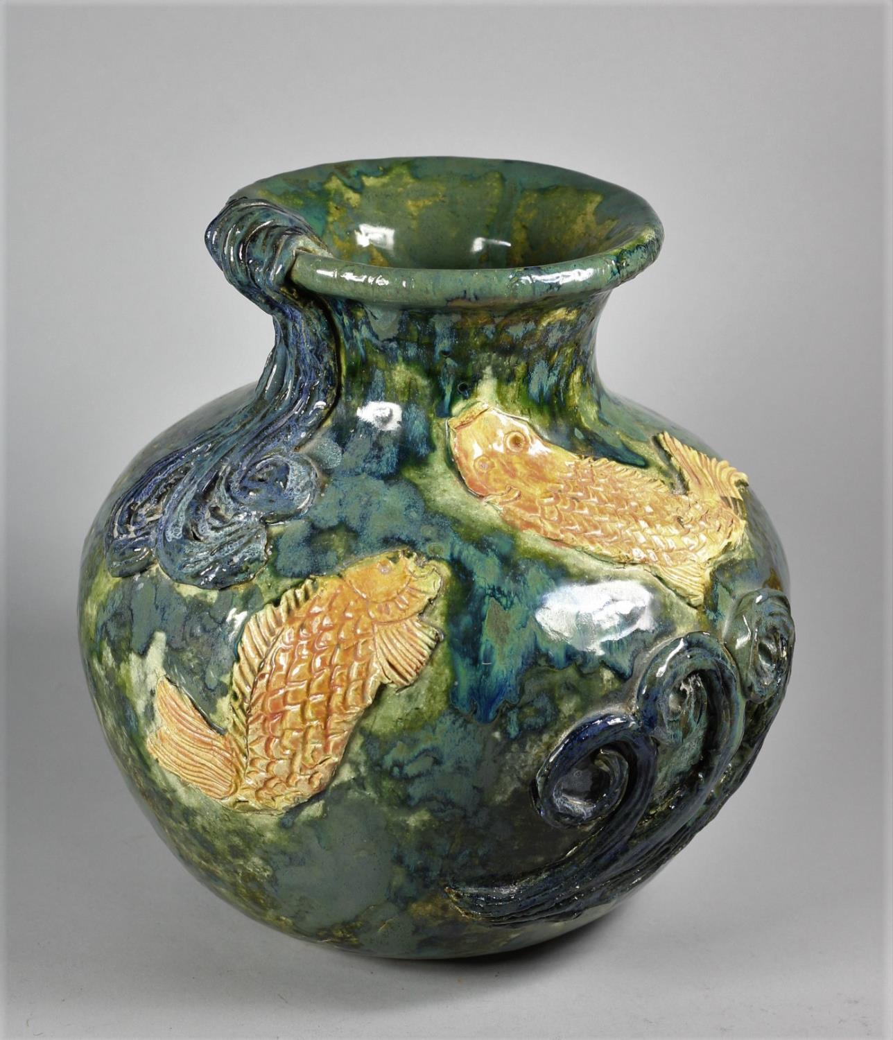 A mid-20th century studio pottery baluster vase, with applied fish and wave motifs, impressed