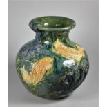 A mid-20th century studio pottery baluster vase, with applied fish and wave motifs, impressed