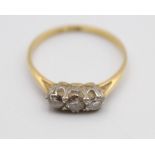 An 18ct gold three stone diamond ring, claw set with brilliant cut stones, total weight