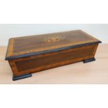 A 19th century Swiss music box with rosewood and boxwood inlay, the single comb movement with