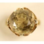 An 18K pale citrine dress ring, claw set with a brilliant cut stone, diameter 16 mm, size K, 7 gms.