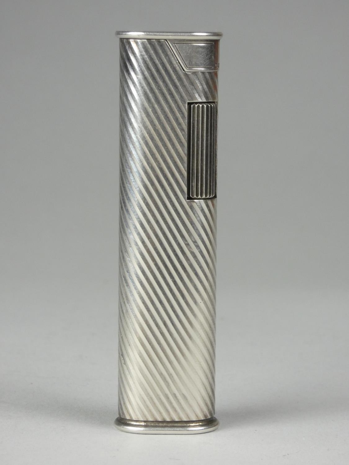 A Dunhill white metal roller lighter with reeded decoration, signed Dunhill F66, length 7cm