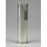 A Dunhill white metal roller lighter with reeded decoration, signed Dunhill F66, length 7cm