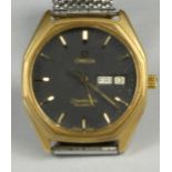 Omega Seamaster; a gentleman's stainless steel quartz day/date wristwatch, the black dial with baton